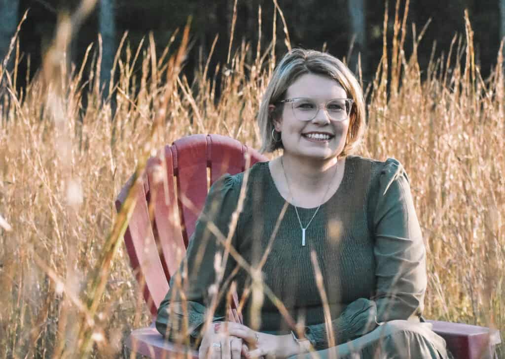 lyndsie sitting in field