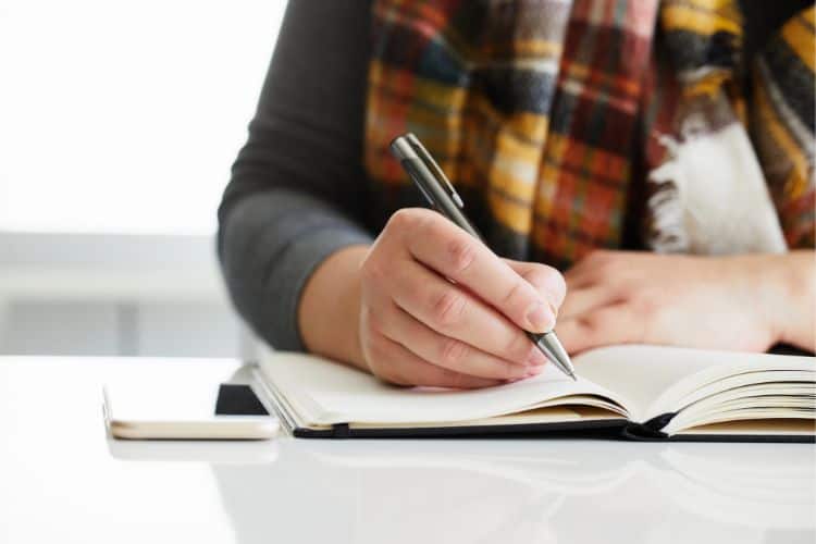 woman writing in a journal
