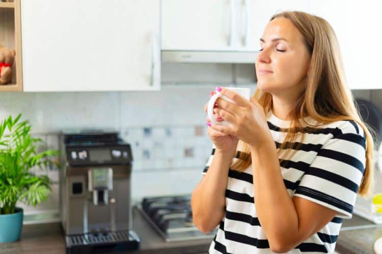 smiling woman drinking a coffee